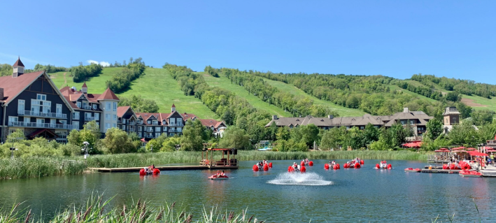 Blue Mountain Village millpond with paddle boats and ski hills